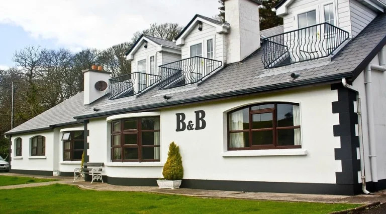 Quaint bed and breakfast near Mayo Dark Sky Festival, with charming white exteriors and lush green surroundings.