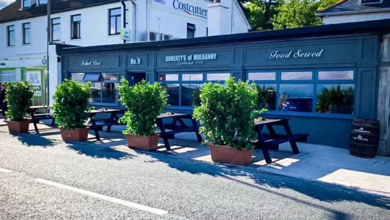 Mulranny pub with outdoor seating, lush plants, and food served, perfect for Mayo Dark Sky Festival attendees.