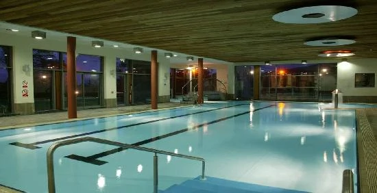 Indoor pool at night in modern leisure centre, Mayo Dark Sky Festival venue, offering relaxation and recreation opportunities.