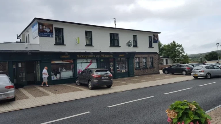 Street view of McLoughlin's of Mulranny, a traditional Irish shop near Mayo, perfect for visitors to the Dark Sky Festival.