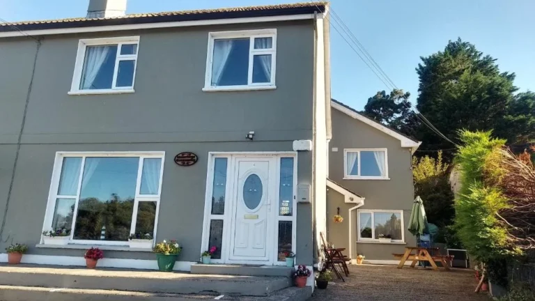 Charming grey house in rural Ireland, perfect for Mayo Dark Sky Festival visitors seeking cosy accommodation.