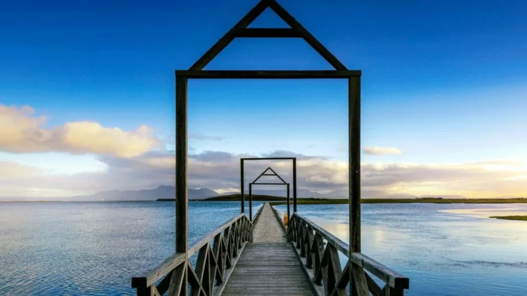 Scenic view of a picturesque wooden bridge over a calm lake, perfect for stargazing at Mayo Dark Sky Festival.