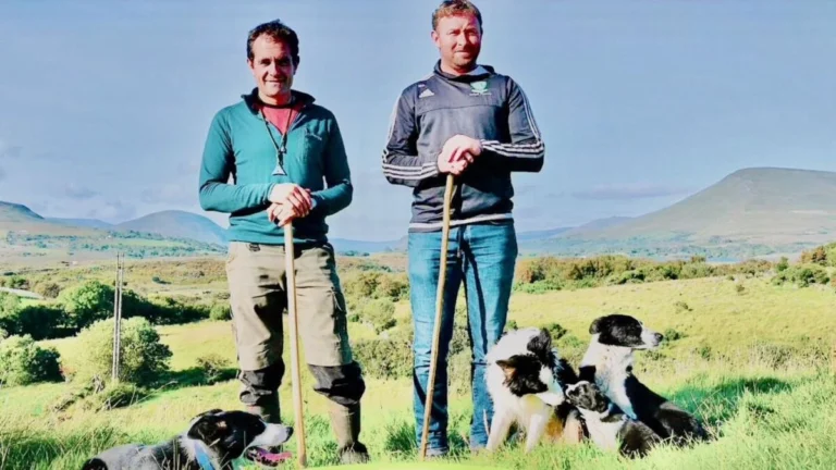 Two men with sheepdogs in scenic Mayo landscape, ideal for Mayo Dark Sky Festival attendees exploring nature.