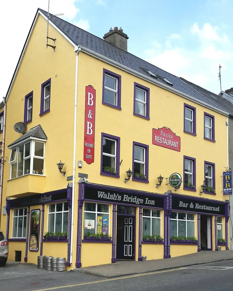 Yellow building with B&B and restaurant signage, offering accommodation near Mayo Dark Sky Festival.